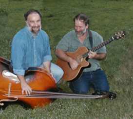 Hank and Mark in the grass with bass and guitat